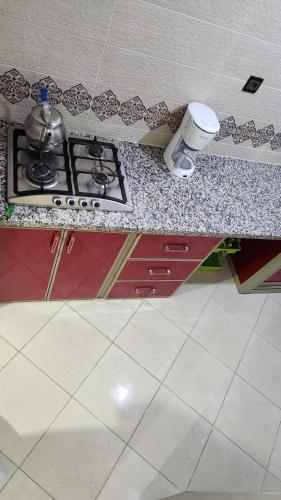 a kitchen counter with a stove with a pot on it at Bright Modern Apartment in Oualidia