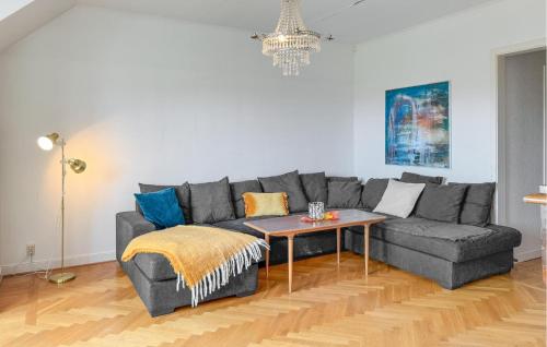 a living room with a gray couch and a table at 2 Bedroom Stunning Apartment In Högsby in Högsby