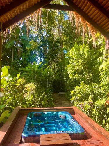 a hot tub in the middle of a garden at Karinya in Clifton Beach