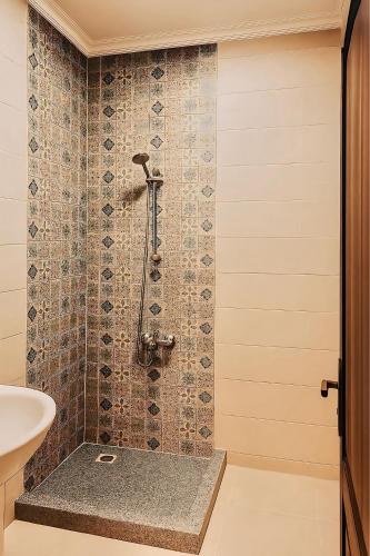 a bathroom with a shower with a sink at 2 Bedroom Modern Flat at Zayed in 6th Of October