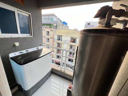 a kitchen with a stove and a window with a building at Luxury Apartment Guest House in Islamabad