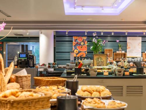 a bakery with bread and pastries on a counter at Pullman Phuket Panwa Beach Resort in Panwa Beach