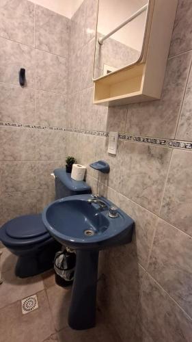 a bathroom with a blue sink and a toilet at La Plaza in Formosa