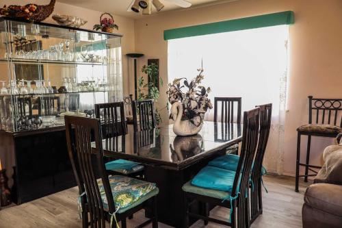 a dining room with a glass table and chairs at The Campeche Town House Townhouse in South Padre Island