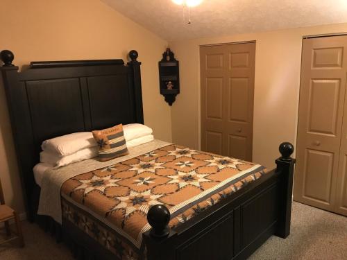 a bedroom with a bed with a quilt on it at Little Main Street Inn in Banner Elk