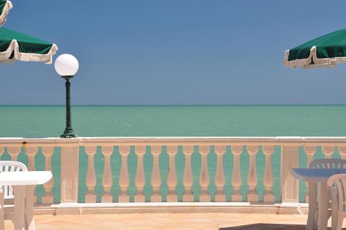 a balcony with a view of the ocean at Hotel Brigantino Non Dista in Porto Recanati