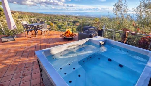 a hot tub on the deck of a house at Rahal Luxury Between Etna & Sea - Heated Jacuzzi & Infinity Pool in Catania