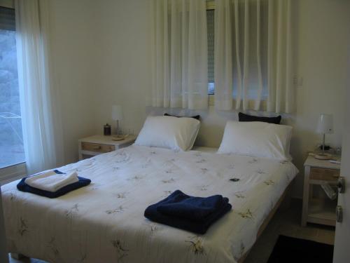 a bedroom with a bed with towels on it at Lovely home above the Kinneret in Karkom