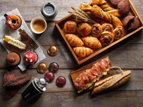 シンガポールにあるSofitel Singapore City Centreのさまざまな種類のパンやペストリーが並んだテーブル