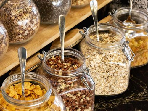 a group of jars filled with different types of nuts at Mercure Paris Saint-Ouen in Saint-Ouen