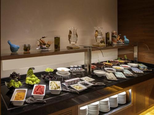 a buffet with a lot of food on a table at Mövenpick Hotel & Thermal Spa Bursa in Bursa