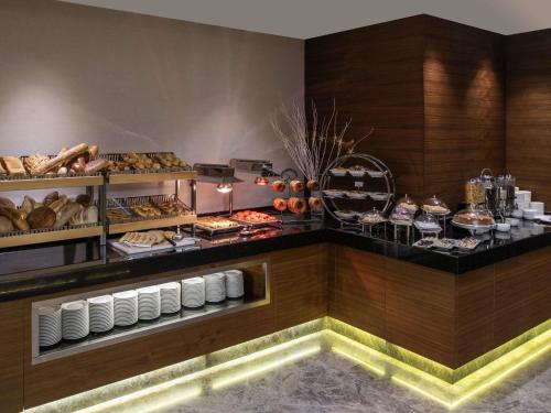 a buffet line with bread and pastries on display at Mövenpick Hotel & Thermal Spa Bursa in Bursa