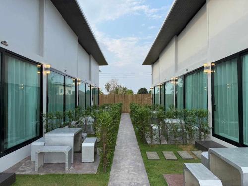 a courtyard of a building with benches and windows at Heaven space resort in Bang Sare