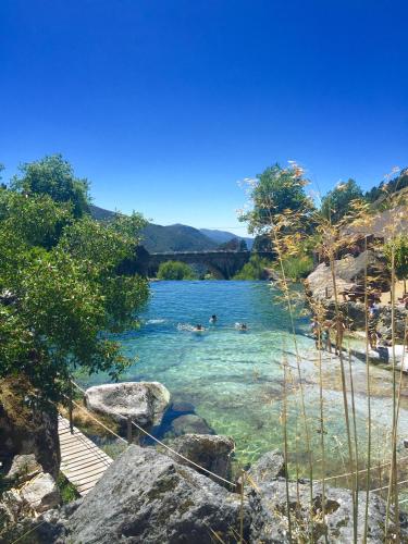 a group of people swimming in a river at Moinhos do Pisão in Povoa Dao