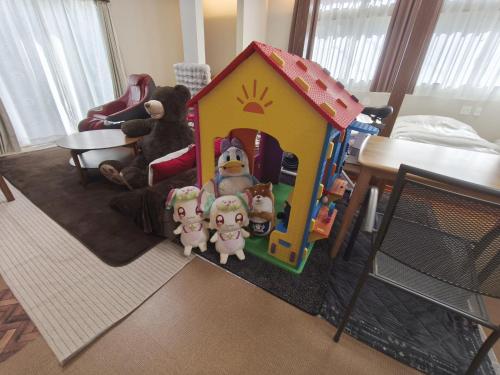 a toy house with a group of stuffed animals in it at スキースノボ BBQ 夏季プール マッサージチェア 舞子スノーリゾート 加賀屋旅館 南魚沼 Kagaya Ryokan 加贺屋旅馆 in Minami Uonuma