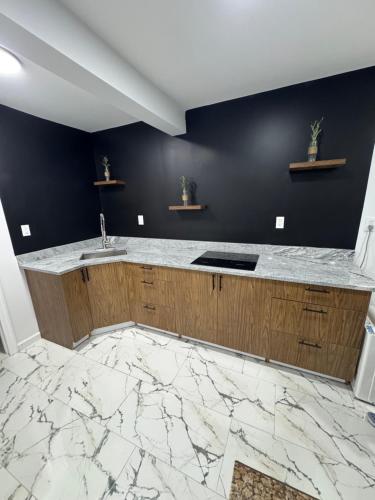 a kitchen with a marble counter and a sink at Apartment near by NYC, EWR and Met Life in East Orange