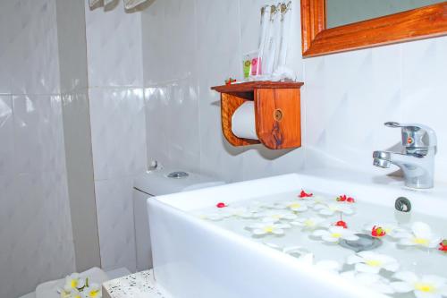 a bathroom with a white tub with flowers on it at The Blanc Residence in Siem Reap