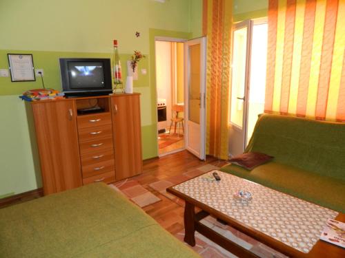 a living room with a couch and a tv at Cora Centru Pitesti in Piteşti