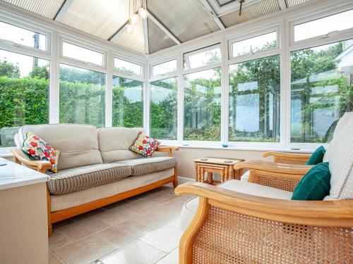 a living room with a couch and windows at Tanglewood in Bugle