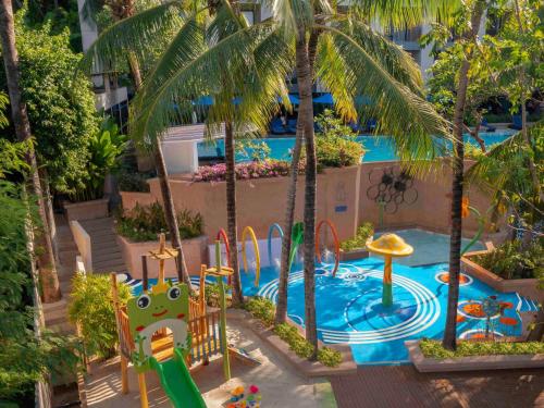 a resort with a pool with a slide and a playground at Novotel Phuket Kata Avista Resort and Spa in Kata Beach