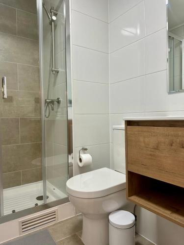 a white bathroom with a toilet and a shower at Central depto 2 dormitorios en distrito Icono in Los Ángeles