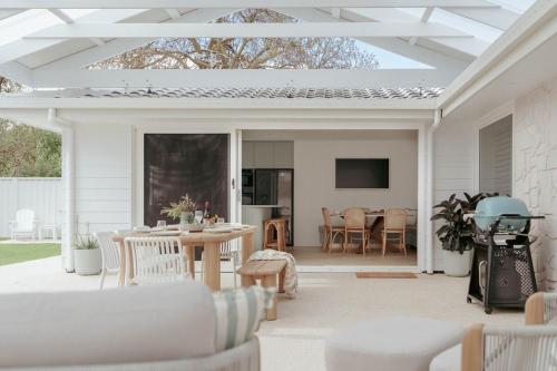an outdoor patio with a table and chairs at White Haven Port Willunga 6 Bedroom group entertainer with Games shed and Pizza oven in Port Willunga