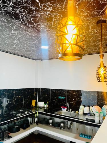a kitchen with a sink and a light fixture at Villa Paraíso Nápoles in Doradal
