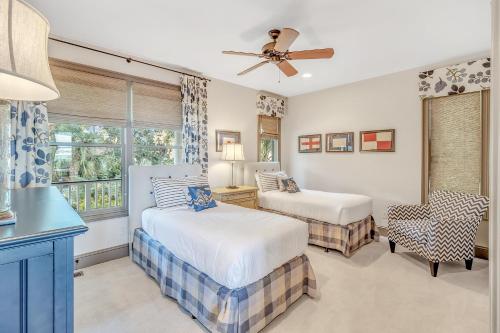 a bedroom with two beds and a window at MG3083: 3083 Marshgate in Seabrook Island