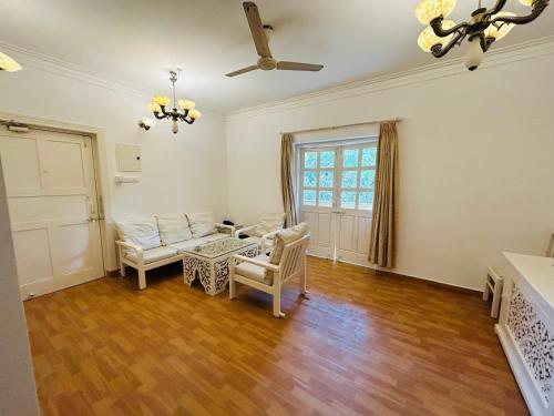a living room with a couch and a table at Candolim beach apartment goa in Candolim