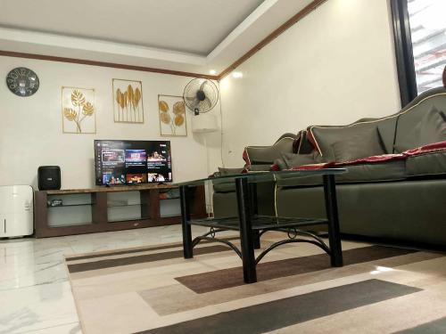 a living room with a couch and a glass table at CasaCavite - Your Chill Hideaway and Mini-Resort Just Minutes from all the Tagaytay-Silang-Nuvali Action! in Silang