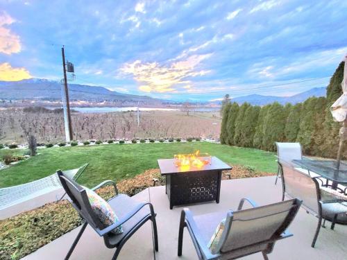 a patio with chairs and a table with a grill at Immaculate Home w/ Mtn and River Views! in East Wenatchee
