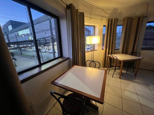 a table and chairs in a room with a window at Sky Aloja Hotel - Ex H Bilbao in Osorno