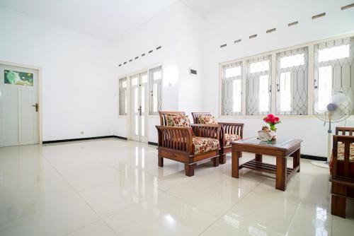 ein Wohnzimmer mit zwei Stühlen und einem Tisch in der Unterkunft Omah Pakualaman Homestay Jogja in Sentool