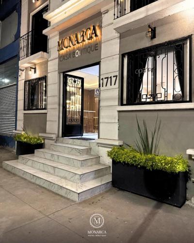 a building with stairs in front of a store at Hotel Boutique Casa Monarca in El Paraíso