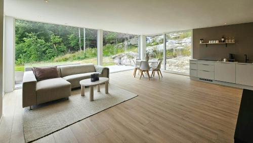 a living room with a couch and a table at Cabin With Sea Views Near Kristiansand in Hamresanden