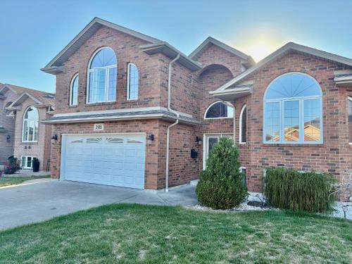 a large brick house with a garage at Cozy and quiet room close to riverside in Windsor
