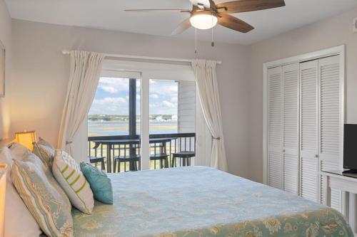 a bedroom with a bed with a view of the ocean at Annabella by the Sea- Ocean, Sound Views Retreat in North Topsail Beach