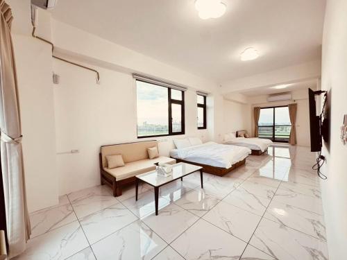 a bedroom with a bed and a couch and a table at 溫適民宿warmth in Zhuangwei
