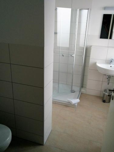 a bathroom with a shower and a sink at Hotel - Stadtvilla Central in Schweinfurt