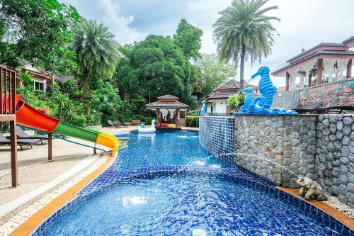 a pool at a resort with a slide at Thai Modern Resort & Spa "Newly Renovated" in Chalong