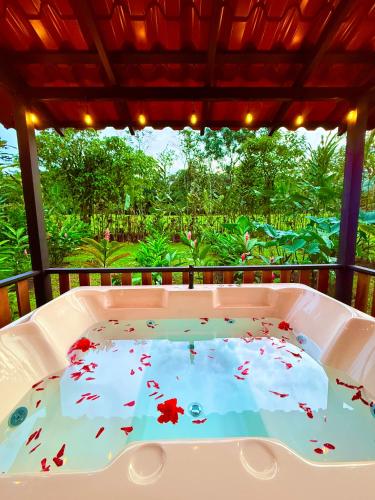 a hot tub on a balcony with a view of a garden at Green Forest Villa in Fortuna