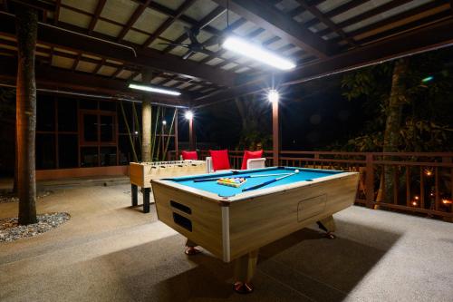 a pool table on a patio at night at Thai Modern Resort & Spa "Newly Renovated" in Chalong