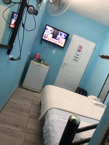 a hospital room with a bed and a flat screen tv at Dormis Totoral in Villa del Totoral