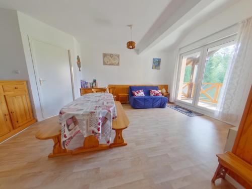 a living room with a bed and a couch at Appartement confortable au pied des pistes - 6 pers - FR-1-834-14 in Prémanon