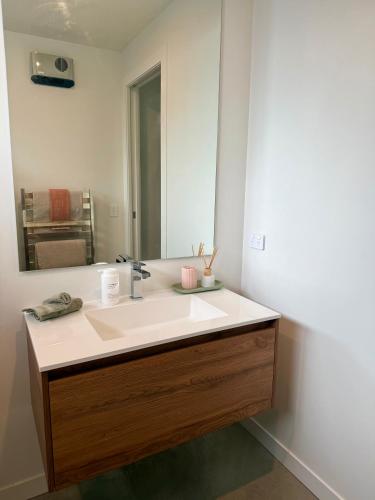 a bathroom with a sink and a mirror at The Green Room in Queenstown Airport