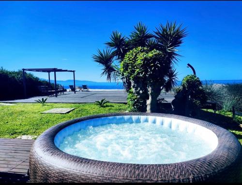 a hot tub in a large wicker tubificialificialificialificialificialificialificial at Maison Plage Mer in Cargèse