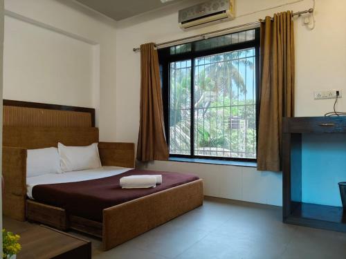 En eller flere senge i et værelse på Grantley - Alibag Beach