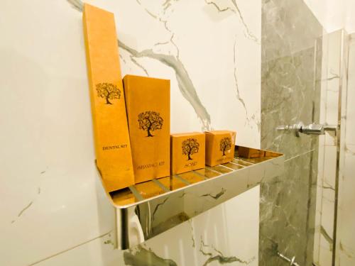 four boxes sitting on a shelf in a bathroom at Hidden Pearl in Kandy