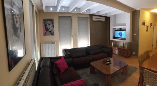 a living room with a couch and a coffee table at Vip apartment Beograd in Belgrade