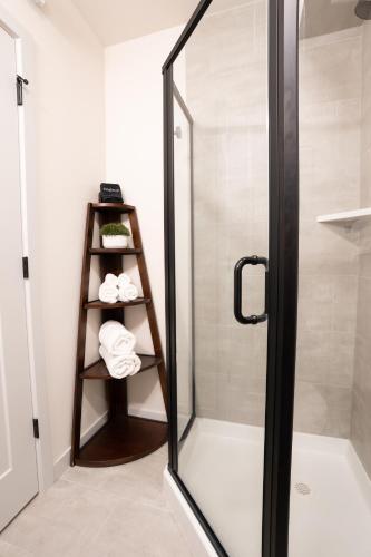 a shower with a glass door in a bathroom at Seattle Townhouse with Rooftop Deck in Ballard in Seattle